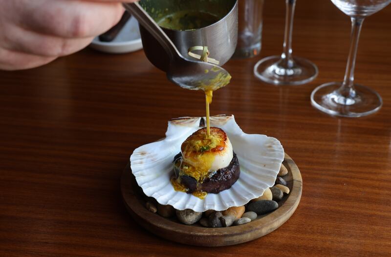 Grilled scallop with pig’s head. Photograph: Dara Mac Dónaill