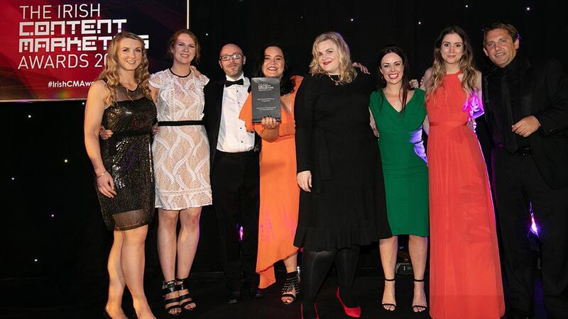 Fionnuala Tohill, Awards Judge presents the Best Content Marketing Programme award to the EY Financial Services Team.