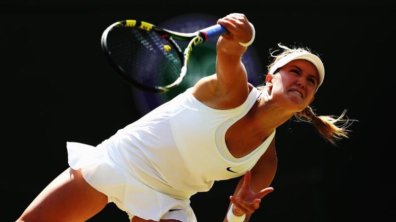Eugenie Bouchard of Canada serves during her match against Angelique Kerber. Photo by Clive Brunskill/Getty Images