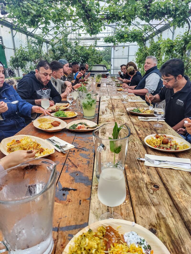 Richard Corrigan and the garden team at Virginia Park Lodge eating lunch cooked by the families of Syrian and Moroccan workers on the estate. Photograph: Sean Vaughan