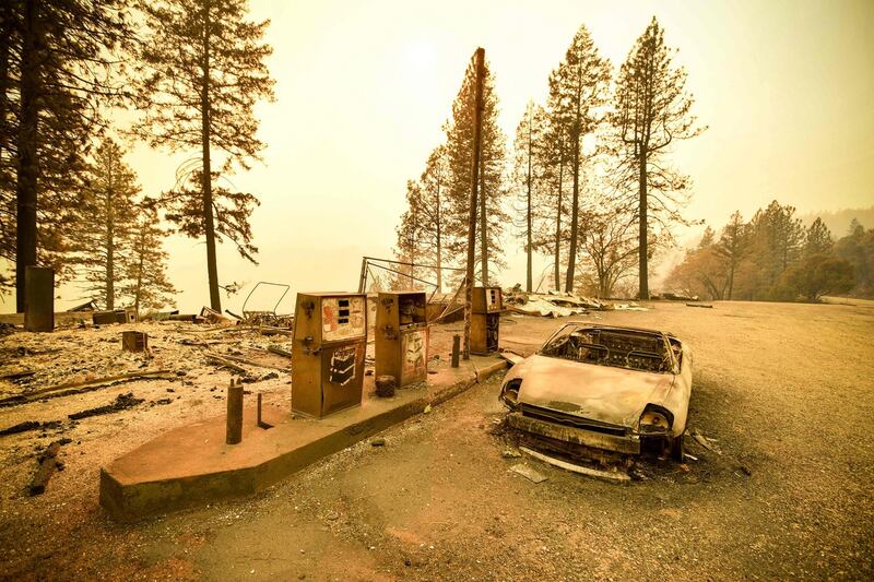 A burnt car and a petrol station  after the Camp fire tore through the region near Pulga, east of Paradise, California on Monday. Photograph: AFP