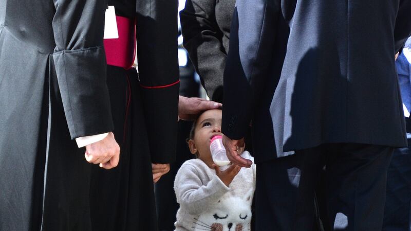 Pope Francis  touching the head of   Tala Al A’Araj (1) from Syria during his visit  to Áras an Uachtaráin. Photograph: Cyril Byrne/The Irish Times