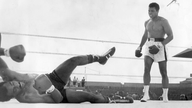 Al “Blue” Lewis at full stretch on the canvas after taking a thunderous left to the jaw from Muhammad Ali in the fifth round of their fight at Croke Park. Photo: Tommy Collins