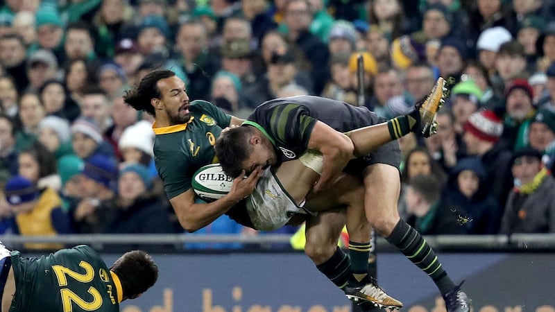 Ireland’s Jacob Stockdale tackles Dillyn Leyds of South Africa. Photograph: Dan Sheridan/Inpho