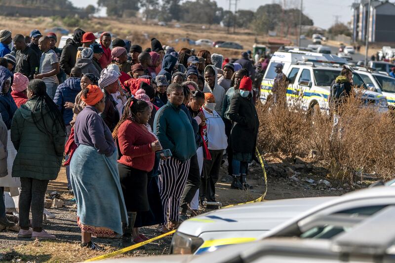 People gather at the scene of the shooting in Soweto, South Africa  Photograph: Shiraaz Mohamed/AP