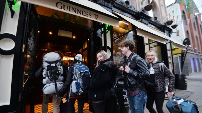 Pierce Bunch, Haley Wells, Bethany Ferraro, Lauren Thalheimer, Alexandra Kononenko, Faison Bunch, on a spring break from Maryland , Origan and New York, arrive at Slatterys Pub on Capel Street direct from the Airport to become some of the first customers to enjoy a pint on Good Friday. Photograph: Alan Betson/ The Irish Times