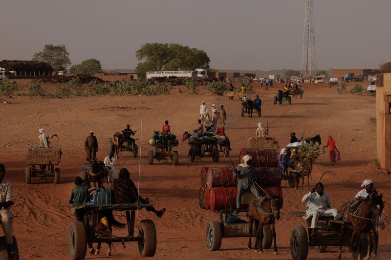 Goods move back and forth on horseback across the border between Sudan and Chad in Adre, Chad. Since the beginning of the war in Sudan in April last year, more than 600,000 refugees have crossed the border from Darfur into Chad. Photograph: Dan Kitwood/Getty Images