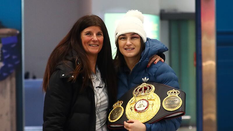 Katie Taylor, with her world title belt, is welcomed home by her mother Bridget in December 2017. Photograph: James Crombie/Inpho