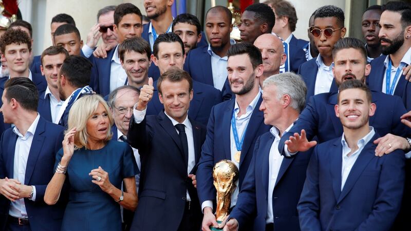 French president Emmanuel Macron and his wife Brigitte Macron pose with the France soccer team before a reception to honour the squad after their victory in the 2018 World Cup, at the Élysée Palace in Paris. Photograph: Philippe Wojazer/Reuters