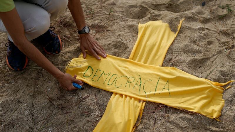 Yellow ribbons shaped as a cross are placed on a beach near Barcelona in support of  jailed Catalan separatist leaders on May 27th, 2018. Photograph: Pau Barrena/AFP/Getty