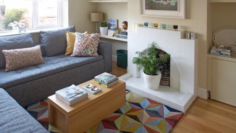 And after:   the addition of a colourful rug, a brighter shade on the walls and some shelves make the room warmer