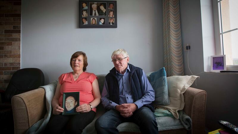 Sean Fallon and his wife Carmel in their Co Leitrim home with a picture of their son Kevin, who took his own life. Photograph: Brian Farrell