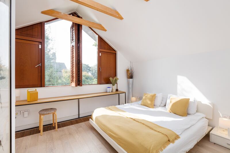 The main bedroom has a pitched roof  and unique Swiss-style triangular window, complete with shutters