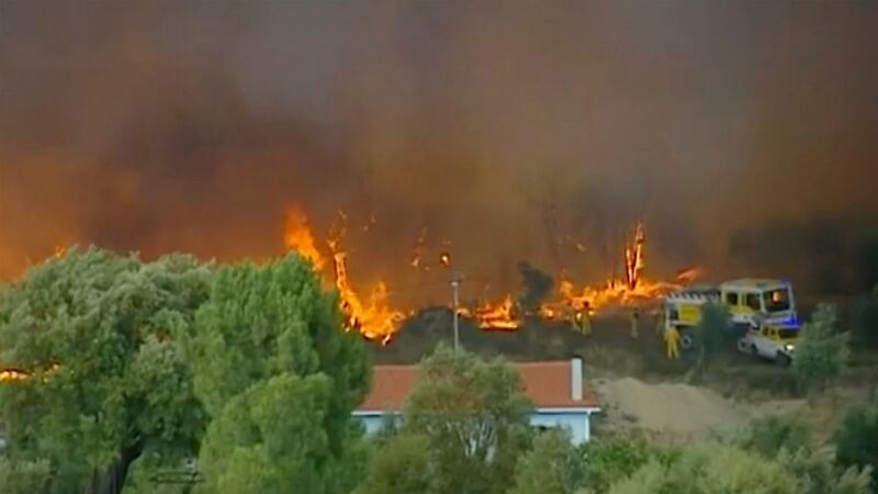 In this grab taken from video on Saturday, members of the emergency services try to extinguish wildfires, in Vila de Rei, Portugal. Photograph: TVI via AP