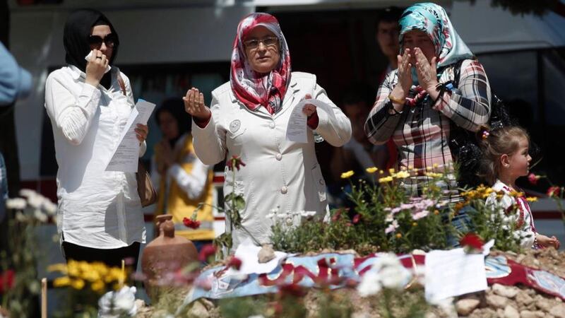 Women in Soma mourn at the graves of people who died in Tuesday’s mine disaster. Turkish police have detained 19 people, including mining company executives and personnel, as part of an investigation into the disaster. Photograph: Osman Orsal/Reuters.