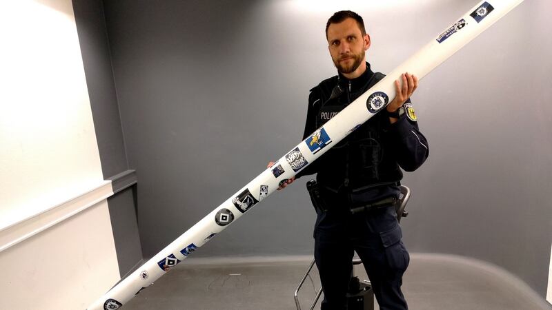 A police officer holds the crossbar after it was recovered on Saturday night. Photo: Federal Police Hamburg handout