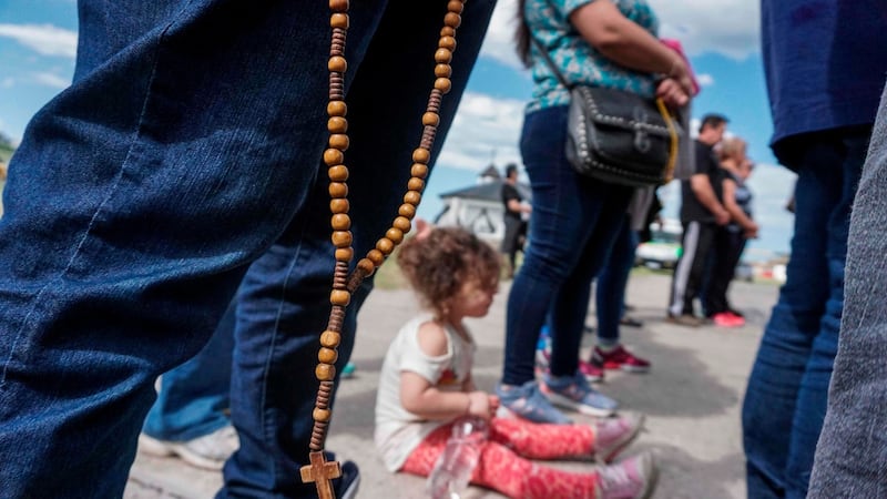 People pray outside Argentina’s Navy base in Mar del Plata, on the Atlantic coast south of Buenos Aires, while the search for the missing ARA San Juan submarine continues. Photograph: Eitan Abramovich/AFP/Getty Images