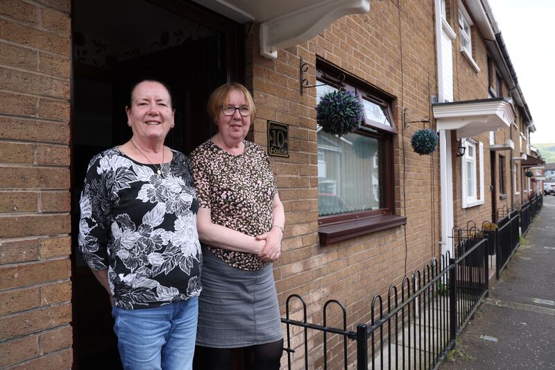 Jean (left) and Patsy  Canavan in Bombay Street in the Falls Road area. The sisters both live close to the peace wall that divides the predominantly Catholic and Protestant neighbourhoods. Photograph: Bryan O’Brien