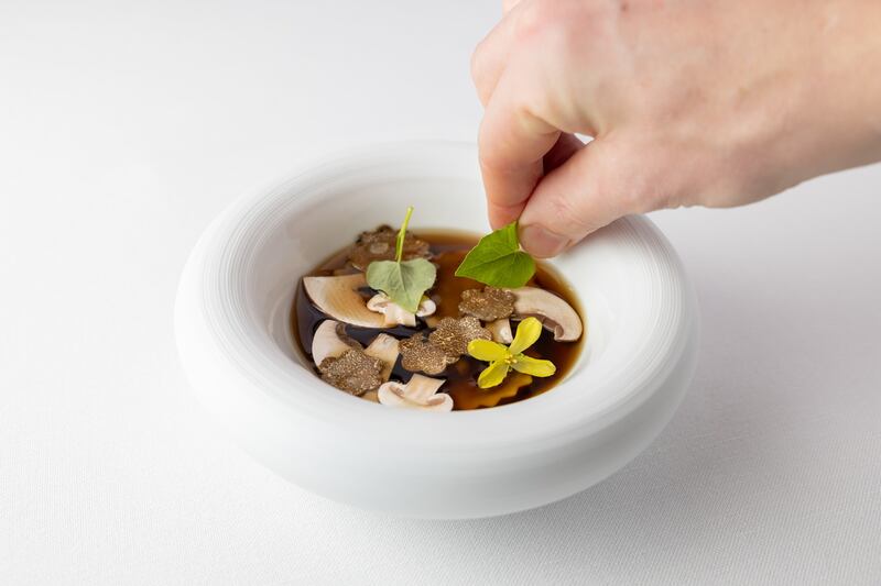 Mushroom consomme with mushroom ravioli, tarragon and summer truffle. Photograph: Naoise Culhane