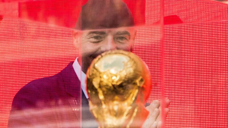 Fifa President Gianni Infantino looks at the World Cup trophy. Photograph: Mladen Antonov/AFP/Getty