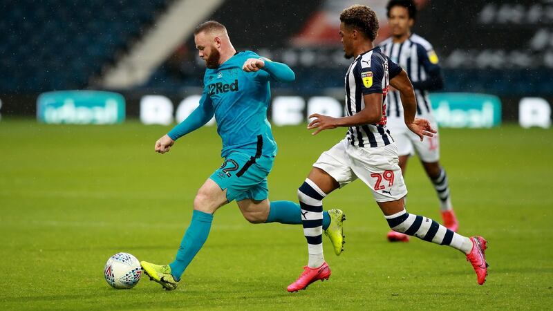 West Brom goalscorer Grady Diangana closes down Wayne Rooney. Photograph:  David Rogers/Getty