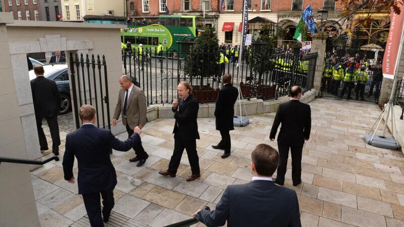 Enda Kenny waited at the exit of the building for several minutes before being led him to his car. Photograph: Dara MacDónaill/The Irish Times.
