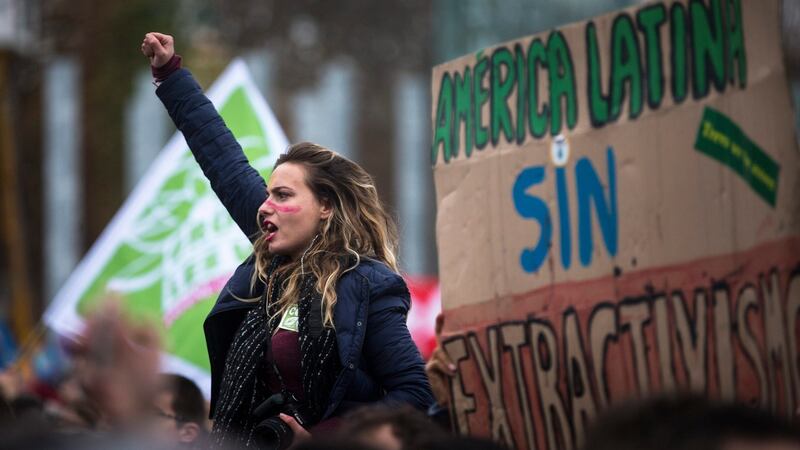A young woman gesticulates and shouts as thousands of people demonstrate for effective climate protection near the Eiffel Tower, Paris, France,  December 12th, 2015. Photograph: Etienne Laurent/EPA