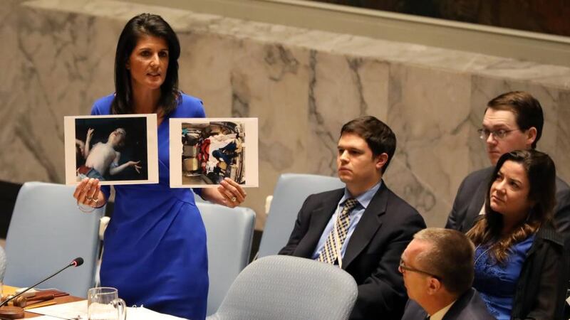 Shayrat retaliation: the US ambassador to the UN, Nikki Haley, shows photographs of gas-attack victims at the Security Council. Photograph: Shannon Stapleton/Reuters