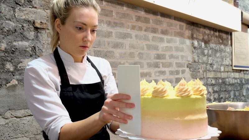 Decorating a strawberry lemonade cake with ombre buttercream