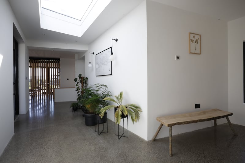 The entrance hall, used as a gallery space to show off some of the furniture range. Pictured is a bench.