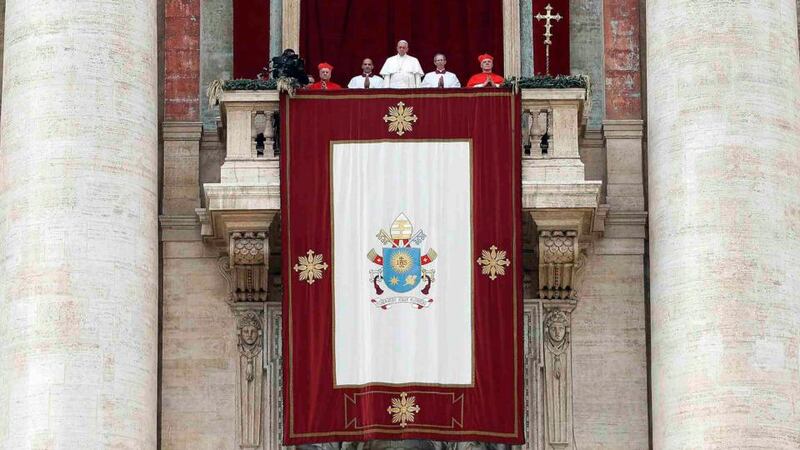 Pope Francis delivers the Urbi et Orbi (to the city and the world) message from the balcony overlooking St Peter’s Square at the Vatican, December 25, 2014. Photograph: Alessandro Bianchi/Reuters