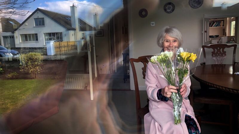 Ellen Creed, from Dublin, with the flowers left outside her door for Mother’s Day after the HSE urged people to comply with social distancing guidelines during the holiday. Photograph: Bryan O Brien