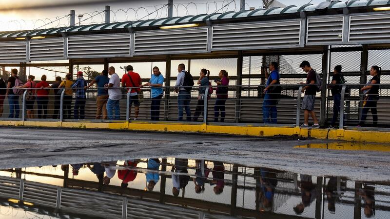 Dozens of people entering the US from Reynosa, Mexico, on the US side of the McAllen-Hidalgo International Bridge in Hildago, Texas. Photograph: Callaghan O’Hare/The New York Times