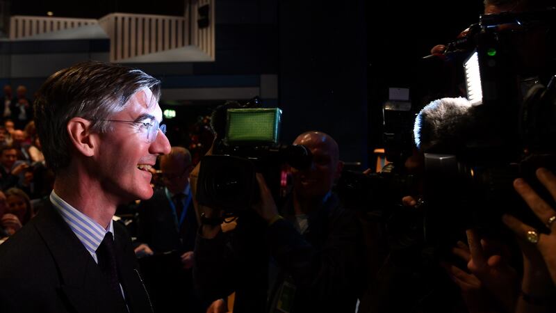 Conservative MP Jacob Rees-Mogg (L) is surrounded by media in the main hall on the first day of the Conservative Party Conference. Photograph: BEN STANSALL/AFP/Getty Images