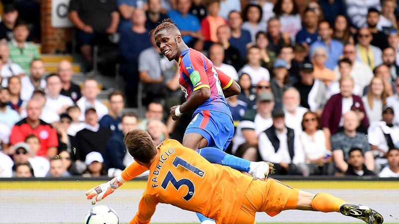 Wilfried Zaha of Crystal Palace scores his team’s second goal past Fulham goalkeeper Fabricio Agosto Ramirez during the Premier League match  at Craven Cottage. Photograph: Justin Setterfield/Getty Images