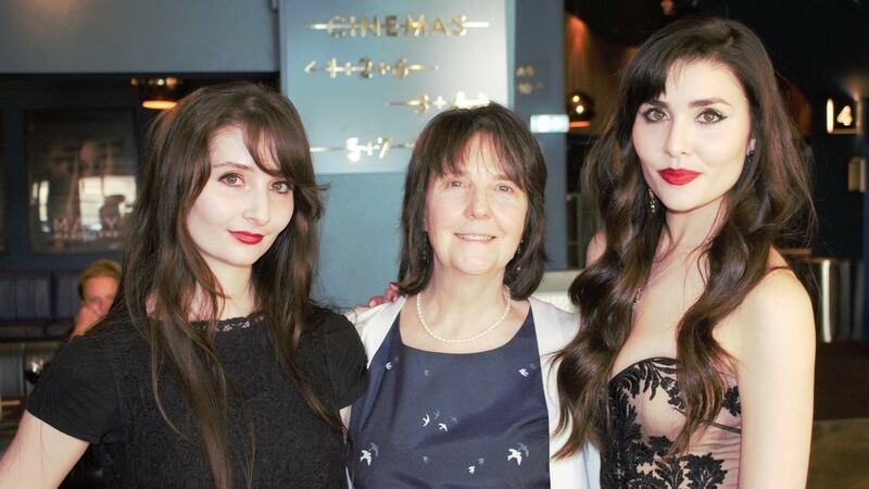 Mary Costello (pictured with her two daughters) would like to be able to fly back from Australia to Antrim.