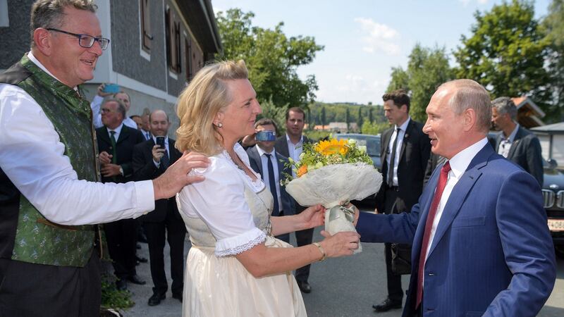 Russian president Vladimir Putin gives flowers to Austrian foreign minister Karin Kneissl during her wedding with entrepreneur Wolfgang Meilinger, far left. Photograph: Alexei Druzhinin/AFP/Getty Images