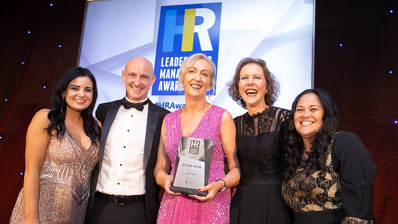 Nick Lawlor, managing director, Employee Financial Wellness, presents the HR Team of the Year award to Trigon Hotels team.