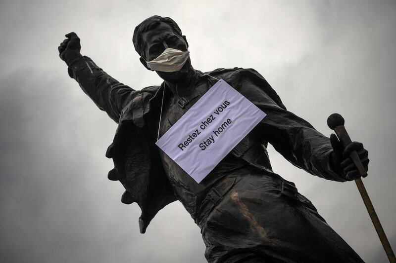 Montreaux, Switzerland: Statue of Freddie Mercury  adorned with  a surgical mask and a sign reading ‘stay home’. Photograph: Jean-Christophe Bott/EPA