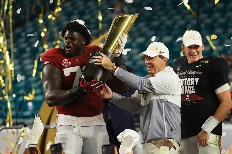 Alex Leatherwood of the Alabama Crimson Tide holds the National Championship trophy alongside head coach Nick Saban following the College Football Playoff win in 2021 over Ohio State Buckeyes at Hard Rock Stadium in Miami Gardens, Florida. Photograph: Mike Ehrmann/Getty Images