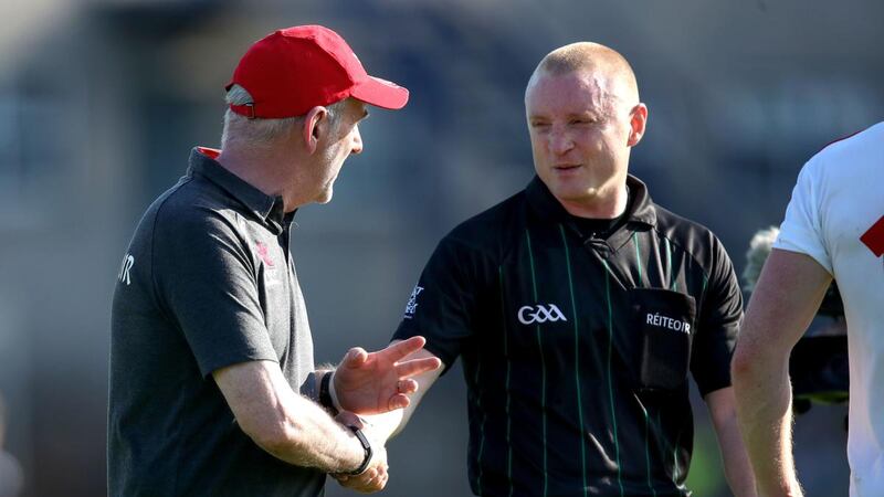 Tyrone manager Mickey Harte speaks to Referee Barry Cassidy after the game, during which Tyrone player Peter Harte was shown a black card. Photograph: Bryan Keane/Inpho