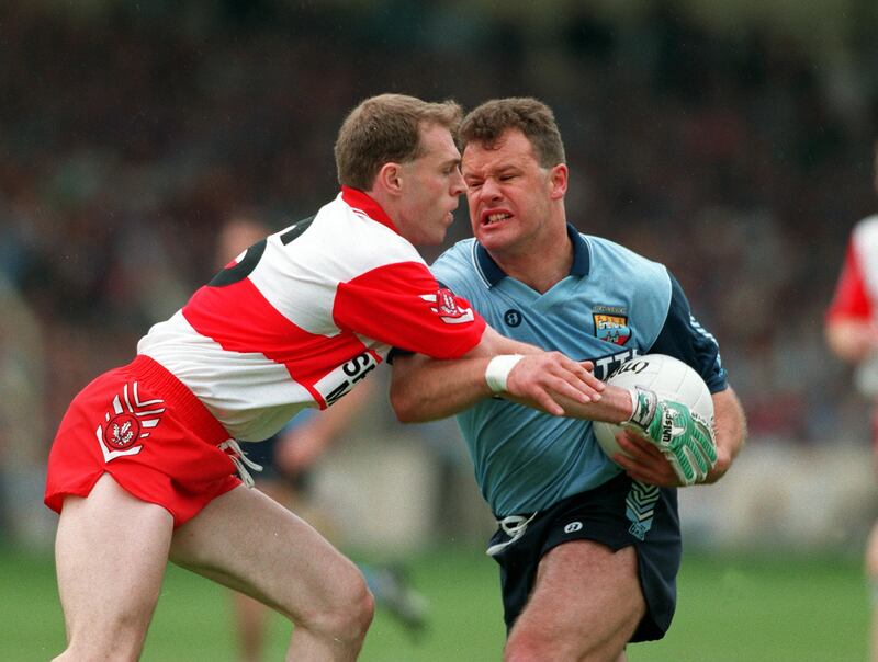 Vinny Murphy of Dublin tries to hold off the challenge from Henry Downey of Derry during the All-Ireland semi-final of 1993. File photograph: Inpho