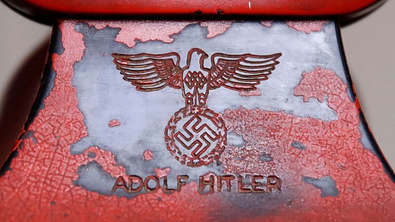 An engraving of a swastika and Adolf Hitler’s name are seen on the back of Hitler’s personal travelling telephone. Photograph: Patrick Semansky/AP