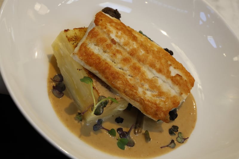 Fillet of turbot, dauphinoise potatoes, spinach, girolles mushrooms and fish sauce at The Dunmore. Photograph: Nick Bradshaw