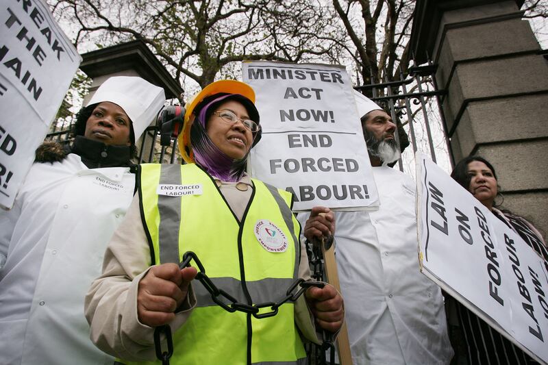 Migrant workers Fauziah Shaari, Anele Jakiel and Muhammed Younis  demonstrating with members of the Migrant Rights Centre Ireland outside the Dáil in 2011. Photograph: Alan Betson