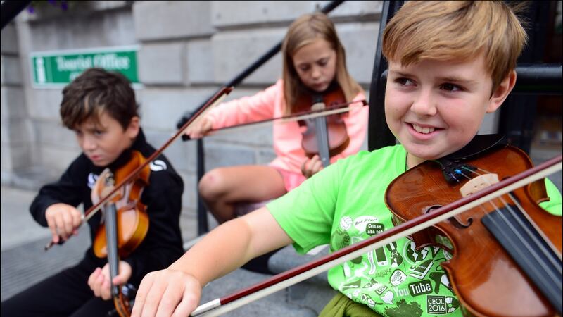 Patrick Connolly (10), Yvie Sharkey (9) and Tommy Sweeney (10) from Clogherhead, Co Louth, at the  Fleadh Cheoil Na hEireann in Drogheda last August. Photograph: Bryan O’Brien