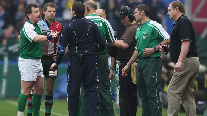 Nick Evans (second from left) is brought back onto the field to replace the injured Tom Williams as referee Nigel Owens talks to Harlequins coach Dean Richards (right) and Leinster officials during the quarter-final. Photograph:  David Rogers/Getty Images
