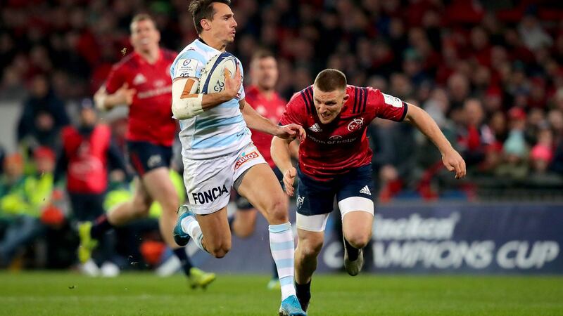 Racing 92’s Juan Imhoff scores his side’s third try of the game despite the attempts of Munster’s  Andrew Conway during the Heineken Champions Cup match at Thomond Park. Photograph: Ryan Byrne/Inpho