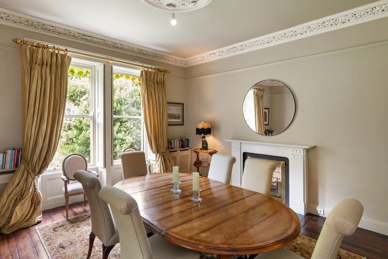 Double doors lead into the diningroom, which has two more sash windows overlooking the garden. 