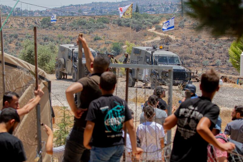 Israeli soldiers and armoured vehicles face protestors near the town of Beita in the West Bank during the weekly demonstration against the Israeli settlement of Evyatar built on Palestinian lands of Mount Sabih. Photograph: Wahaj Bani Moufleh/Middle East Images via AFP